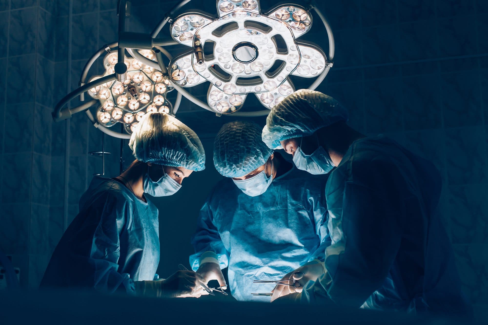 Surgical team working under operating theatre lights